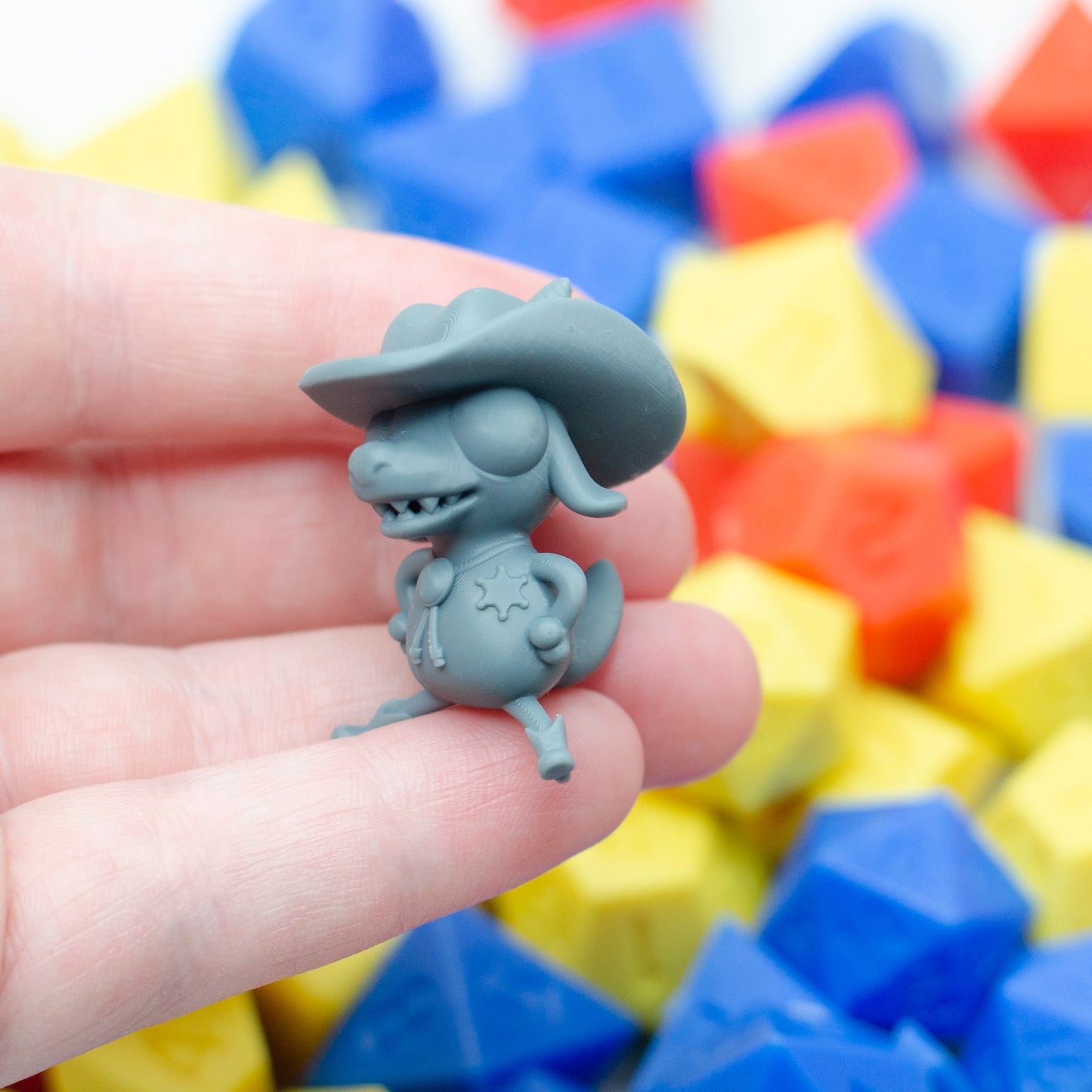 The kobold kowpoke miniature in grey, with cowboy hat, bolo tie and wee little boots.