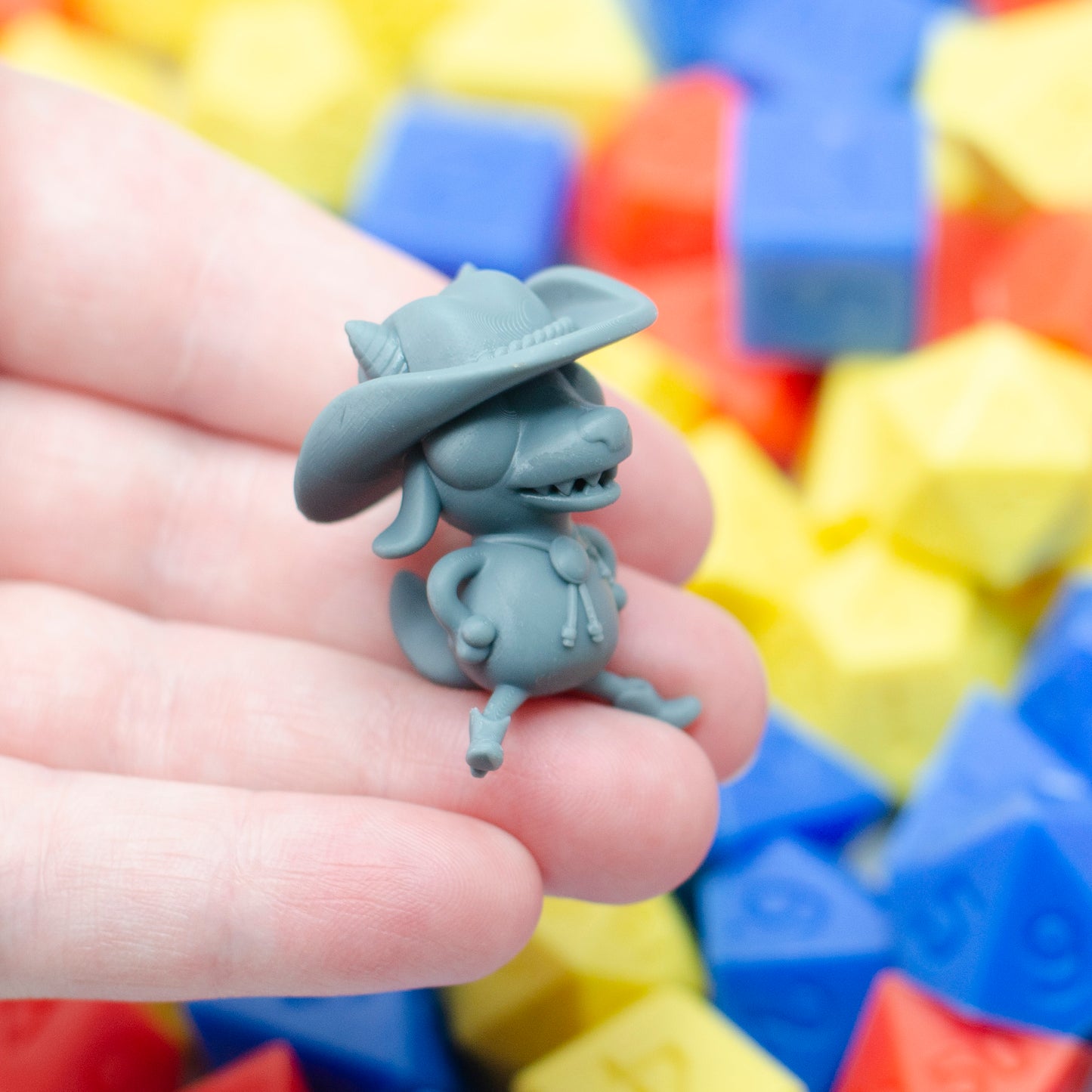The kobold kowpoke miniature in grey, with cowboy hat, bolo tie and wee little boots.
