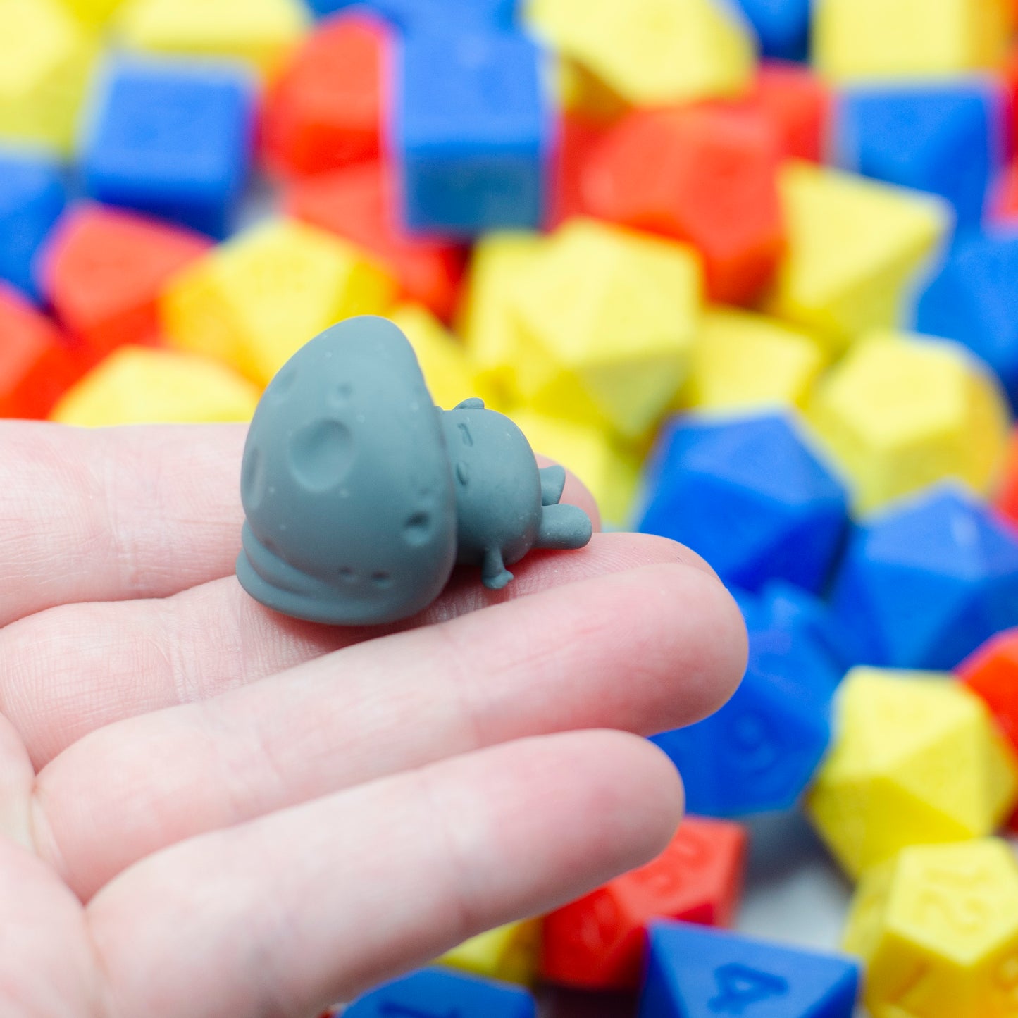A 3d printed mushroom guy laying on its back, holding its tummy and looking tired. showing the cap detail.