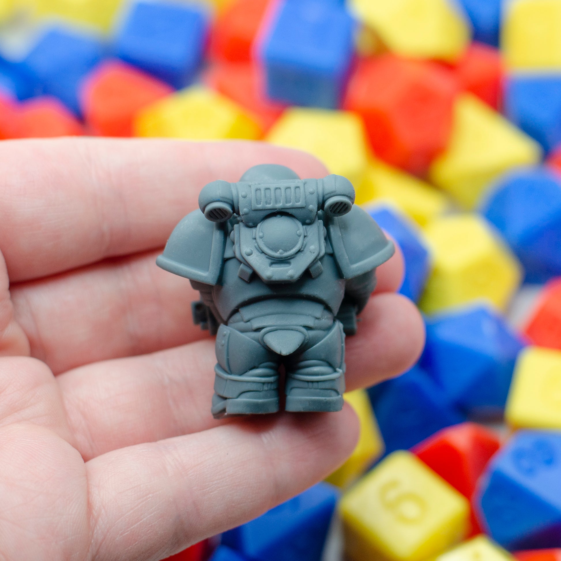 A back view of the 3d printed penguin space marine, showing the power armor backpack and a little tail.