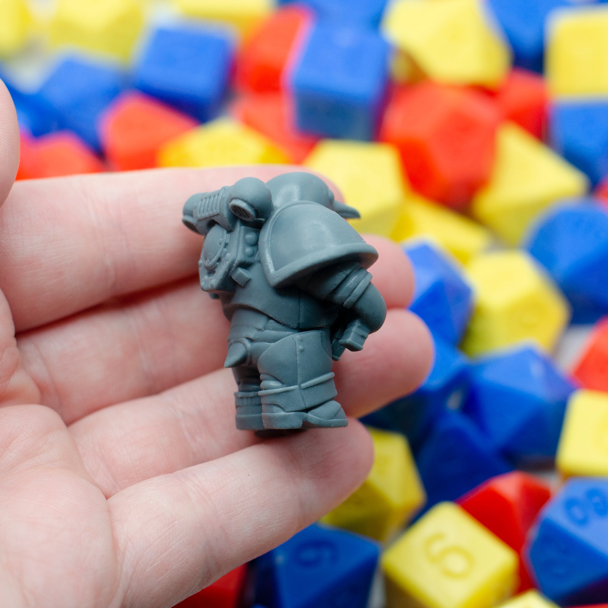 A side view of the 3d printed resin space marine penguin's big ol' pauldrons.