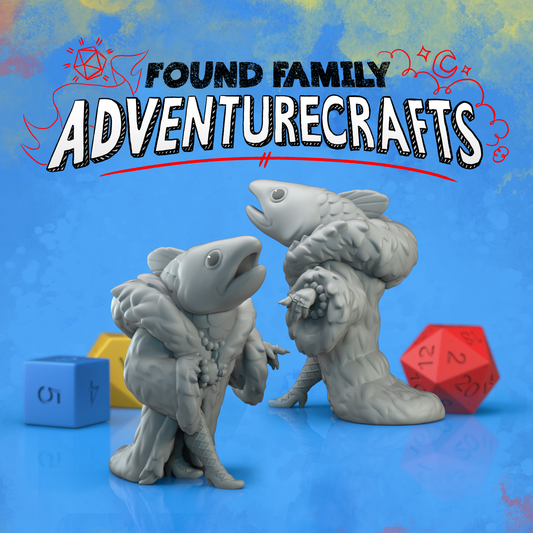 Two fish-like reverse mermaid creature miniatures with dice on a blue background, featuring 'Found Family Adventurecrafts' text.